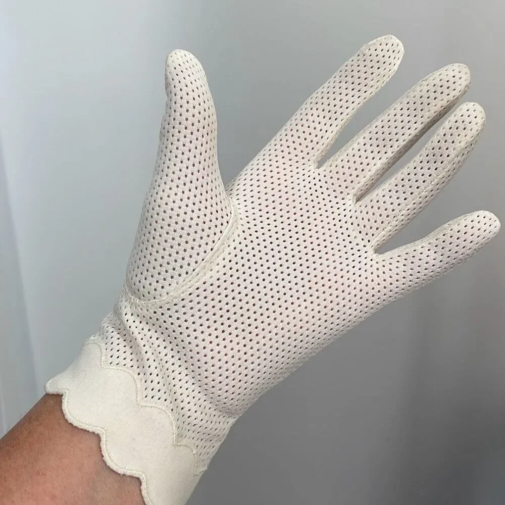 Vintage cream colored perforated gloves scalloped edges.